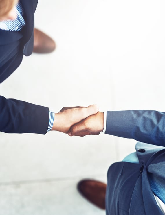 close-up aerial view of two business partners shaking hands