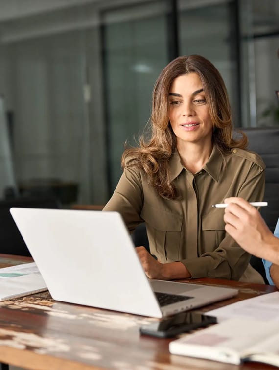 woman pointing at computer screen