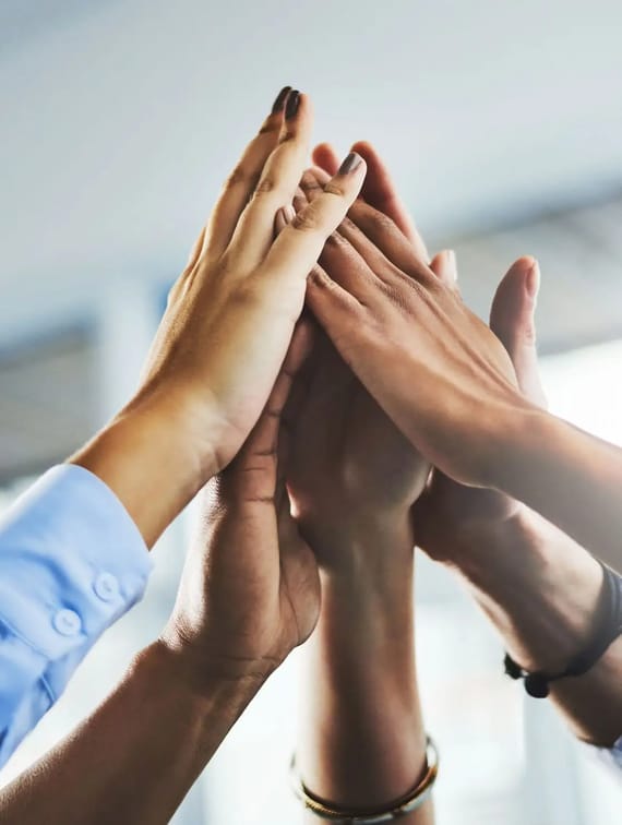 people putting their hands together in the middle