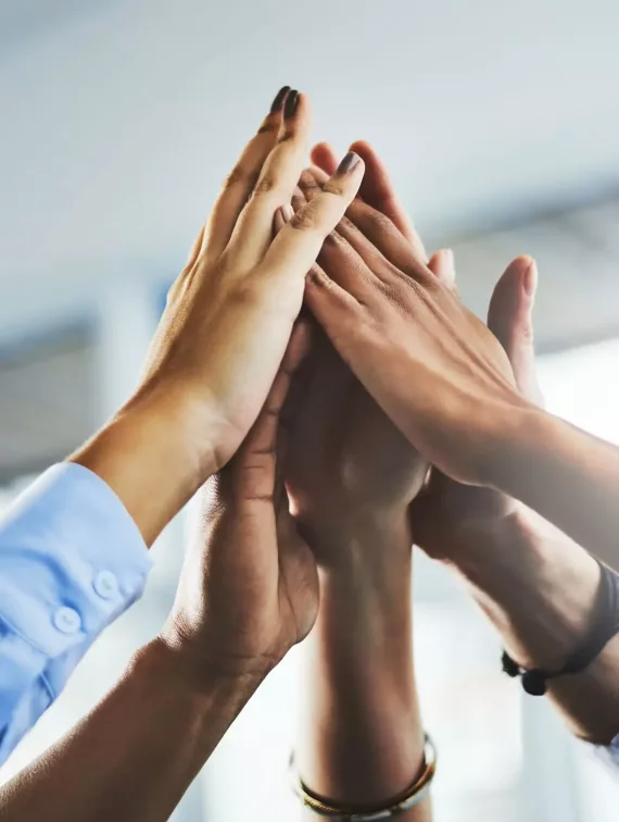 people putting their hands together in the middle